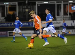 Cameron McGeehan shapes to take a shot with Gary Roberts in pursuit