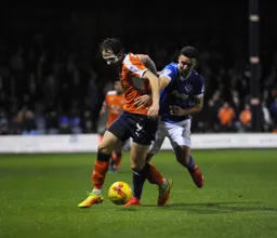 Danny Hylton tries to force his way past Enda Stevens