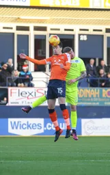 Alex Gilliead wins the ball in the air