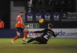 Jordan Cook chips the ball over Lloyd Allinson but misses the target