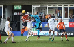 Will Norris punches the ball away from Glen Rea