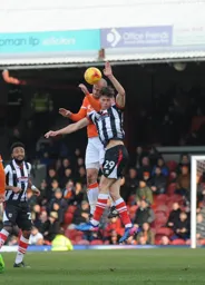 Scott Cuthbert heads the ball away from Calum Dyson