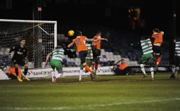 Johnny Mullins sends a header towards the goal