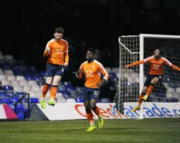 Jordan Cook jumps for joy after scoring the first goal
