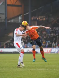 Glen Rea and Jimmy Smith both go in for a header