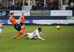 Oscar Threlkeld dives in but cannot prevent Ollie Palmer taking a shot at goal
