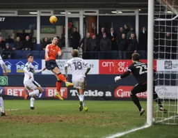 Danny Hylton heads towards goal