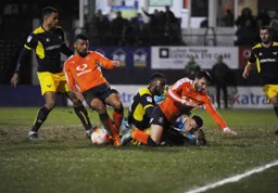 Isaac Vassell in a goal mouth scramble