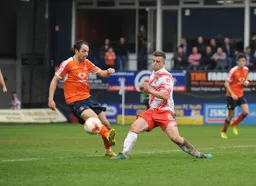 Danny Hylton hooks the ball away from Steve Schumacher