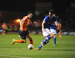 Danny Hylton takes on the defender