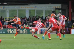 Ollie Palmer fires in a shot as future Hatters Jordan Clark and Matty Pearson attempt to block