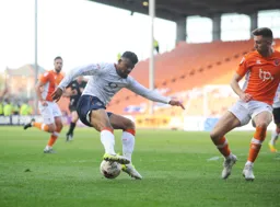 Isaac Vassell takes on the defender