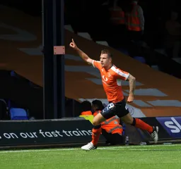 James Collins wheels away in delight after scoring the second goal