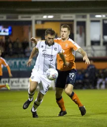 James Collins is beaten to the ball by former Hatter Joe Davis