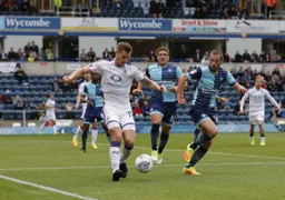 James Collins controls the ball with former Hatter Michael Harriman in close attendance