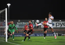 An anxious moment for the Morecambe defence as Harry Cornick closes in
