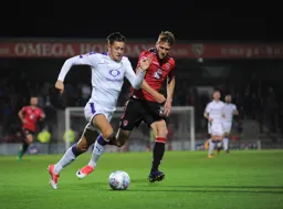 Harry Cornick glides past Patrick Brough