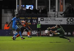 Pelly-Ruddock Mpanzu has his shot saved by Craig Ross