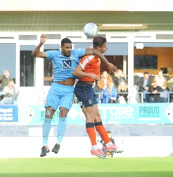 Harry Cornick in an aerial duel for the ball with Luke Willis