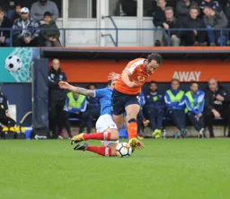 Danny Hylton just avoids a lunging tackle