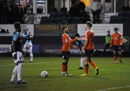Kavan Cotter takes a handshake from Luke Gambin after scoring the third goal