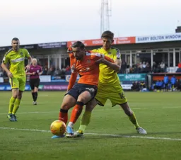 Elliot Lee shields the ball away from Shaun Brisley