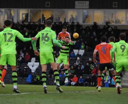 Dan Potts gets above Scott Laird to power a header towards goal