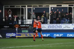 Danny Hylton and James Collins embrace after the latter had scored the first goal