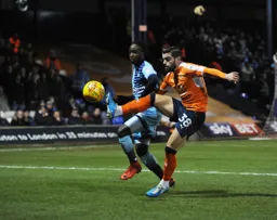 Elliot Lee under pressure attempts to control the ball