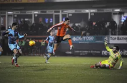 Scott Brown blocks the ball as Harry Cornick attempts to charge the ball down
