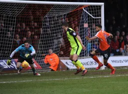 Jake Jervis closes in as Christy Pym scrambles to gather the ball