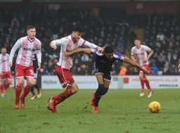 Jake Jervis fights for possession with former Hatter Jonathan Smith
