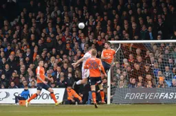 Alan Sheehan heads the ball clear
