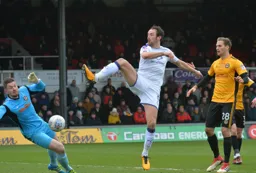 Danny Hylton takes a wild swing at the ball