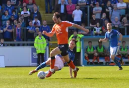 Danny Hylton rides Jamie Devitt`s tackle