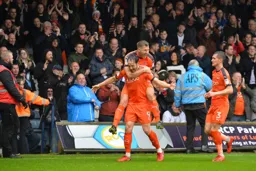 Danny Hylton celebrates his goal with James Collins and Dan Potts