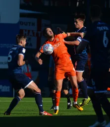 Danny Hylton jumps for the ball
