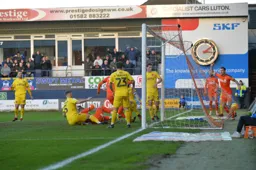 Harry Cornick (obstructed) taps in as James Collins celebrates behind the goal