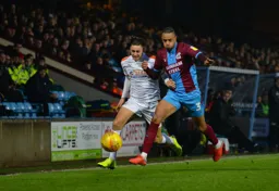 Harry Cornick takes on the defender