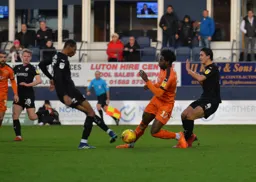 Pelly Mpanzu caught between two players