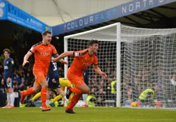 Matty Pearson runs off to celebrate with an overjoyed James Collins behind him