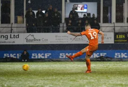 James Collins takes the penalty and scores