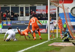 Danny Hylton heads the ball over the line