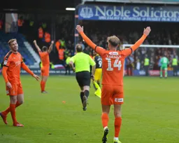 Harry Cornick arms aloft celebrating the win
