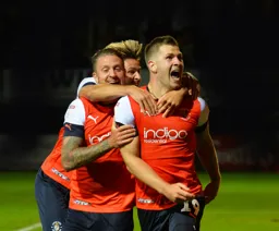 James Collins celebrates with George Moncur and Harry Cornick after bringing the game to 3-3