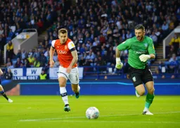 James Collins chasing down goalkeeper Kieran Westwood for a loose ball