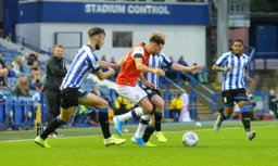 Harry Cornick getting the beating of two Sheffield Wednesday players, while Graeme Jones watches on