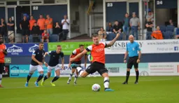 James Collins about to bring the Town level from the penalty spot