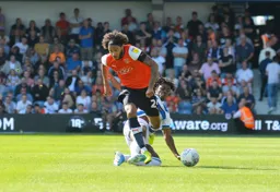 Izzy Brown tries to carry the ball away from Eberechi Eze
