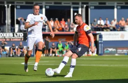 Ryan Tunnicliffe keeps the ball moving as Tom Eaves closes in